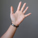 female hand wearing mica oval stretch bracelet