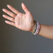 woman's palm modeling chrysocolla cuprite, rose quartz, rhodonite bracelet set