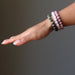 woman's arm modeling chrysocolla cuprite, rose quartz, rhodonite bracelet set