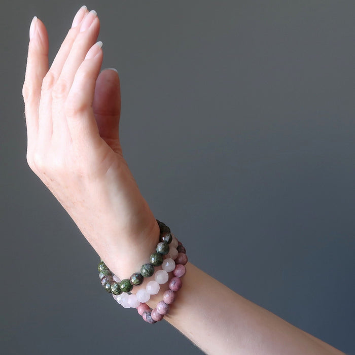 female hand modeling chrysocolla cuprite, rose quartz, rhodonite bracelet set