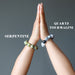female hands in prayer modeling tourmaline quartz and serpentine bracelet set
