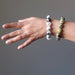 female hand modeling tourmaline quartz and serpentine bracelet set