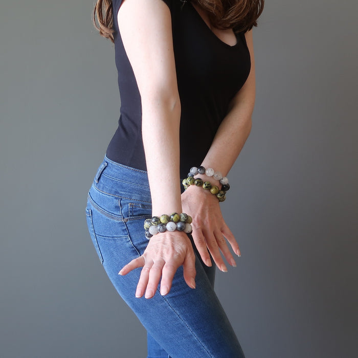 female hands modeling tourmaline quartz and serpentine bracelet set