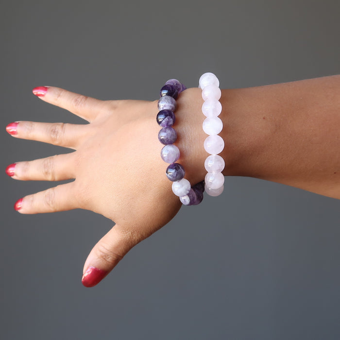 female hand modeling amethyst and rose quartz bracelet sets
