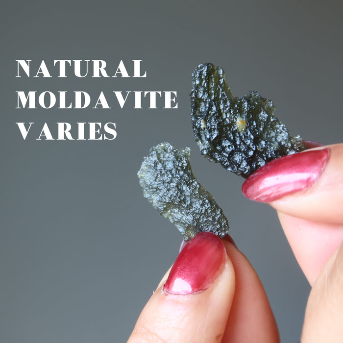 hands holding real moldavite pieces to show variations