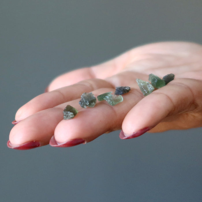 7 green raw moldavite tektites on hand