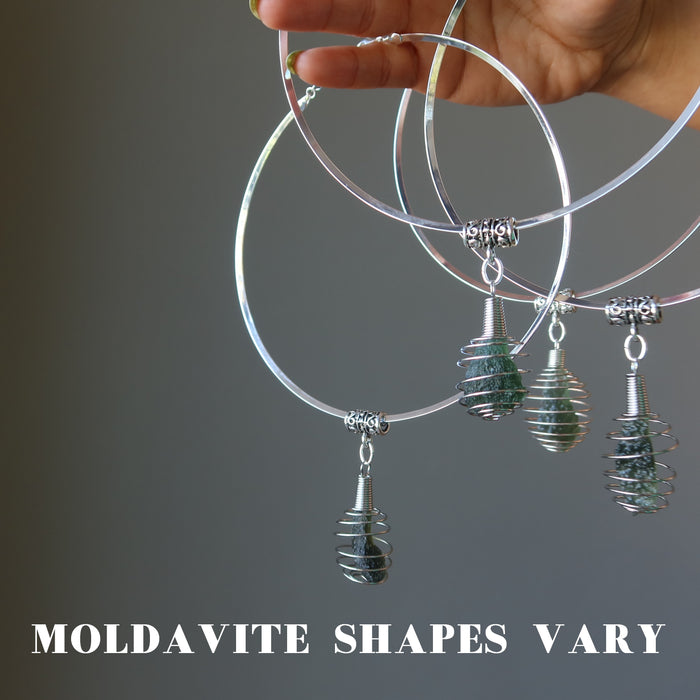 hand holding four moldavite choker necklaces to show shapes vary