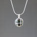 moldavite tumbled sterling silver cage necklace 