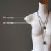 mannequin wearing two moldavite necklaces at 18" and 30 inches