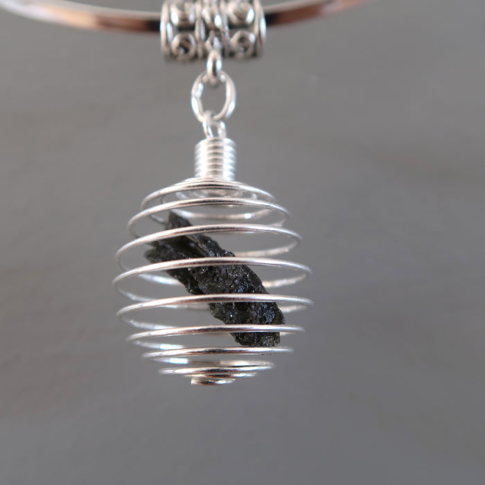 raw moldavite in silver cage necklace