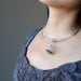 moldavite cage necklace on female
