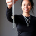 sheila of satin crystals holding a moldavite sterling silver necklace