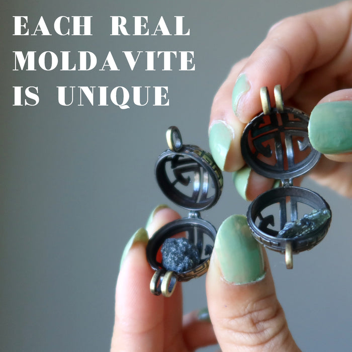 hands holding two lockets containing moldavite rough stones