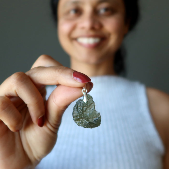 woman modeling moldavite pendant