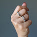 hand wearing moldavite rings