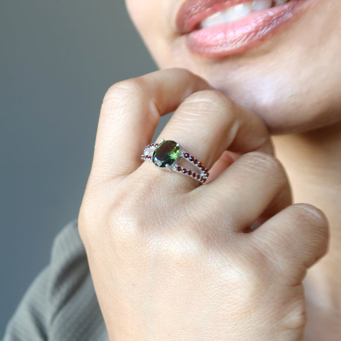 hand wearing moldavite garnet ring