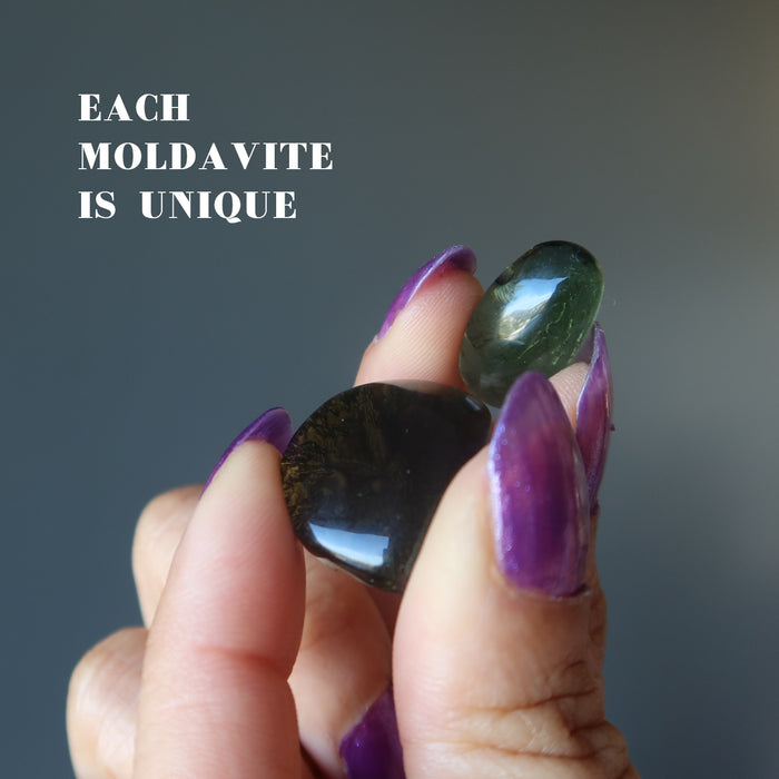 hand holding two moldavite