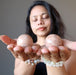 sheila of satin crystals meditating with two peach moonstone spheres