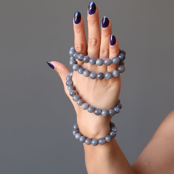 female hand modeling 4 black moonstone round beaded stretch bracelets