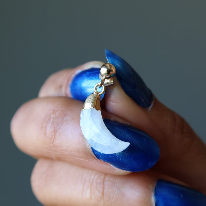 hand holding a rainbow moonstone faceted moon earring