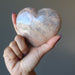 hand holding peach moonstone heart