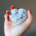 hand holding moonstone tourmaline heart
