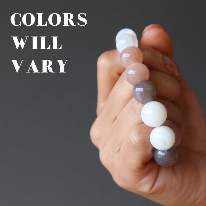 hand holding a moonstone bracelet showing that colors will vary