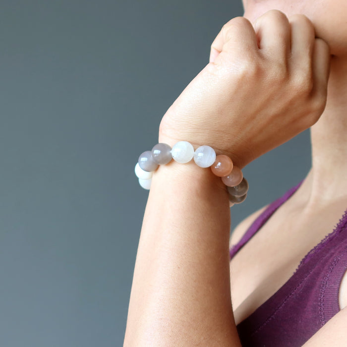 hand wearing multi-colored moonstone stretch bracelet
