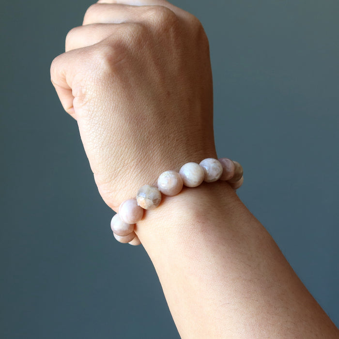 female wearing peach moonstone bracelet 