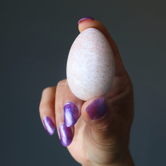 hand holding Cream Moonstone Egg 