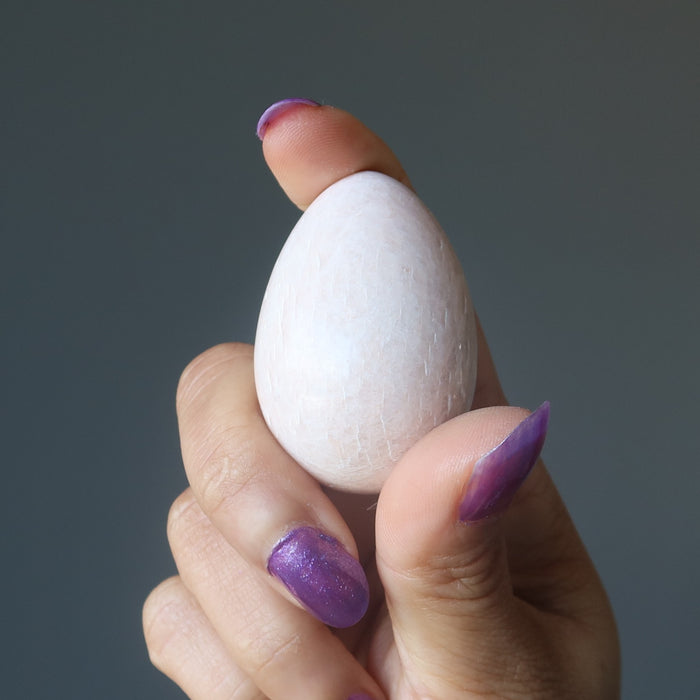 hand holding Cream Moonstone Egg 