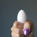 fist holding Cream Moonstone Egg 