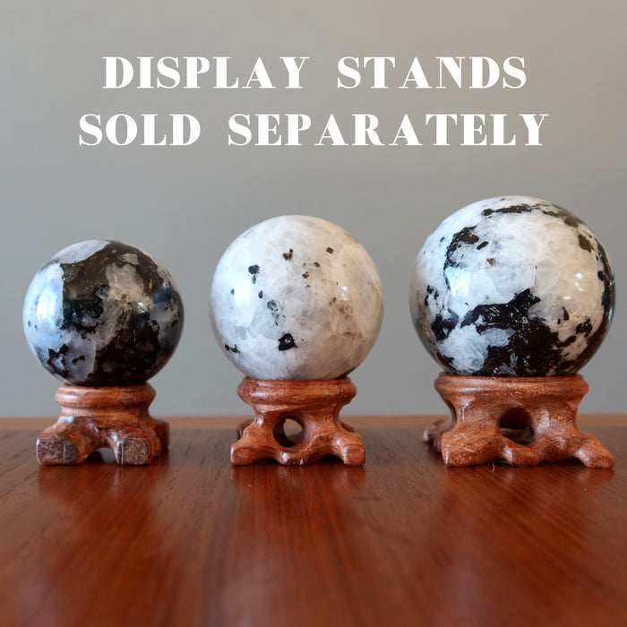 three moonstone tourmaline spheres on display stands that are are sold separately