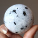 moonstone tourmaline sphere in hand