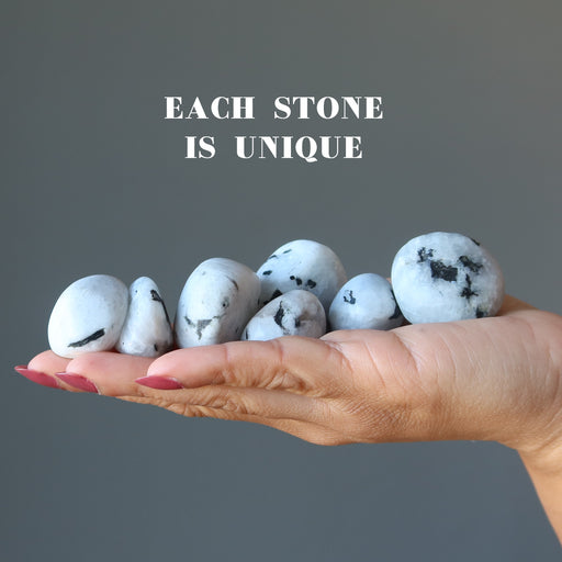 hand full of tumbled moonstone tourmaline stones