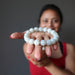 sheila of satin crystals with white moonstone bracelet in her outstretched palm