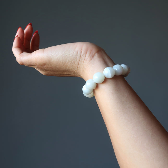 model hand wearing white moonstone bracelet