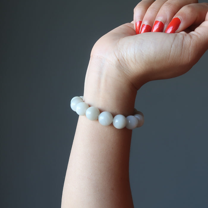 female model hand wearing white moonstone bracelet