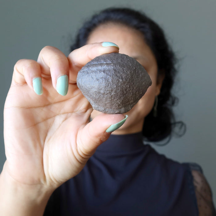 sheila of satin crystals holding a natural moqui stone