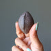 hand holding a natural moqui stone
