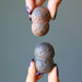 hands holding conjoined twin moqui marble pair
