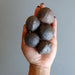 set of 5 brown moqui marble stones in palm of hand
