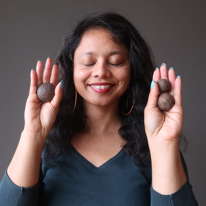 sheila of satincrystals holding set of three moqui marble stones in ascending sizes in her palms