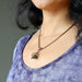 moqui marble stone in vintage cage on antique copper snake chain necklace on female neck