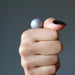 hand holding silver muonionalusta meteorite sphere 