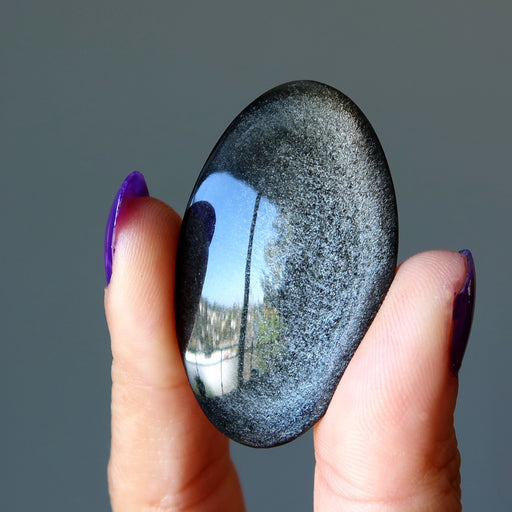 holding oval cabochon Silver Sheen Obsidian