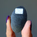 showing raw back side of oval Silver Sheen Obsidian cabochon