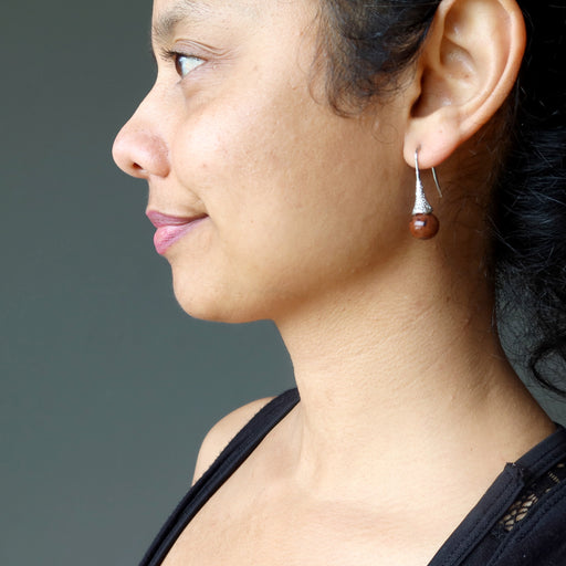 sheila of satin crystals wearing mahogany obsidian in silver dangle earrings