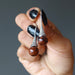 hand holding mahogany obsidian in silver dangle earrings