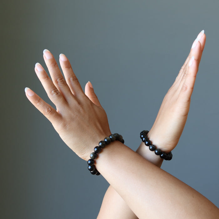 model wearing Gold Sheen Obsidian Bracelets on both wrists